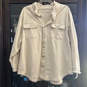 Cream color distressed jean jacket.